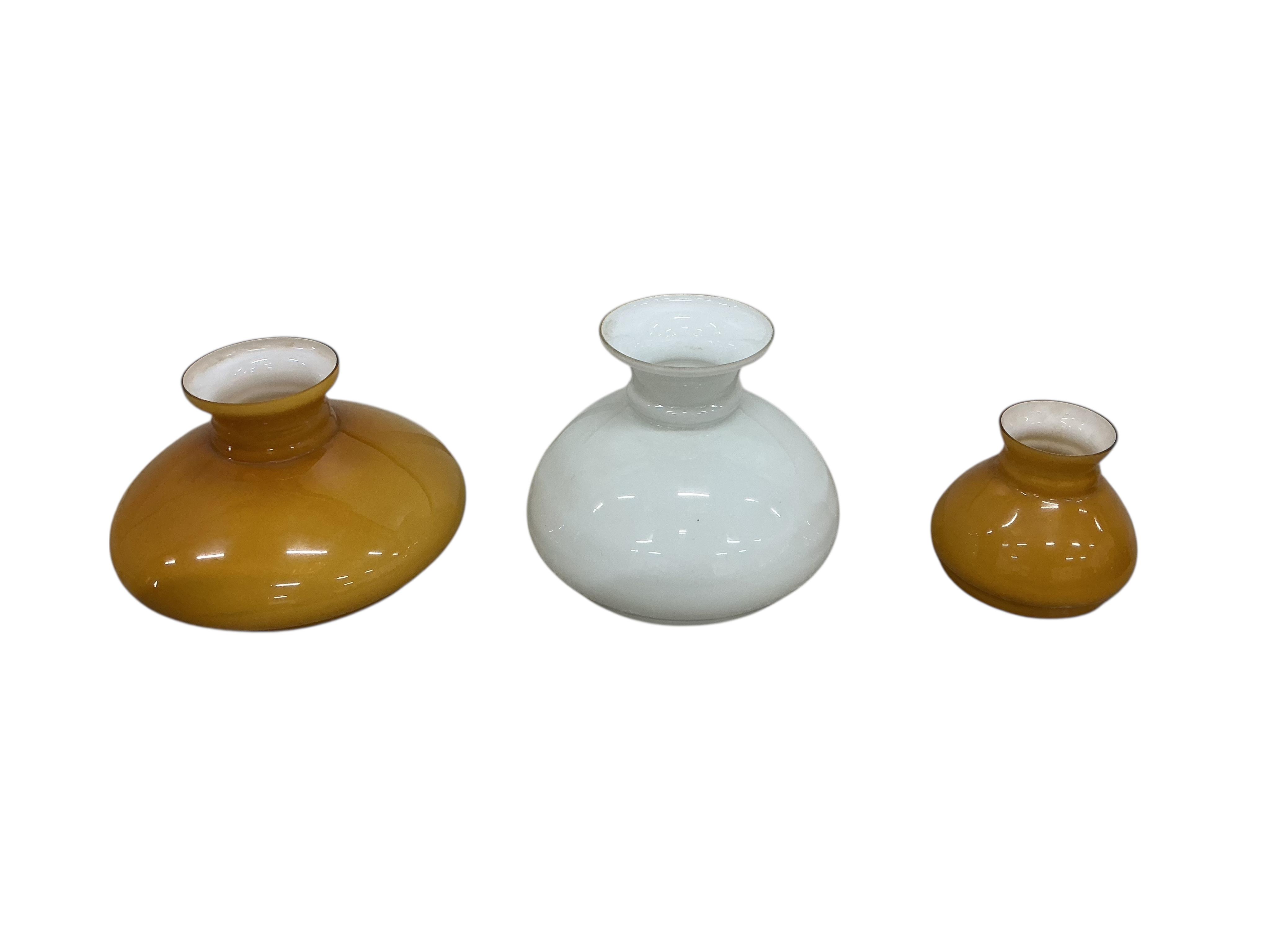 A pair of late Victorian brass wall fitting gas lamps with odd shades (converted), and another electric wall light